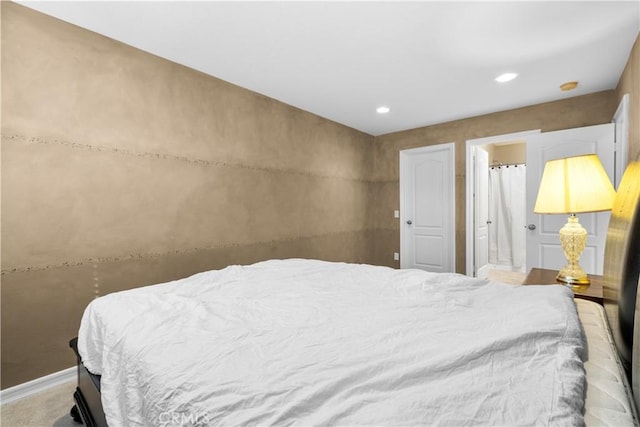 carpeted bedroom featuring ensuite bathroom