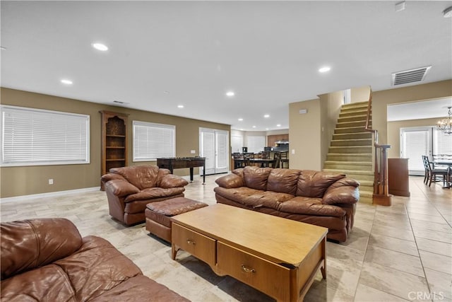 living room featuring light tile patterned floors and a chandelier