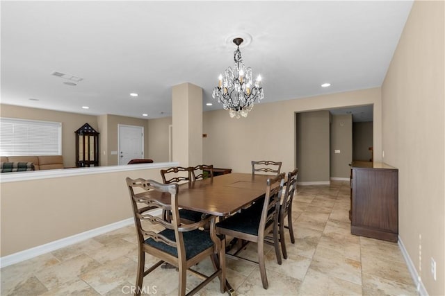 dining area with an inviting chandelier