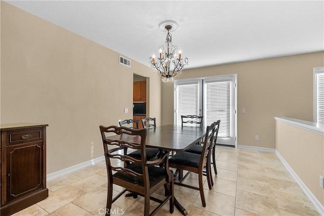 dining area featuring an inviting chandelier