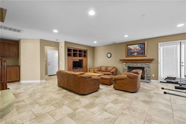 living room featuring a stone fireplace