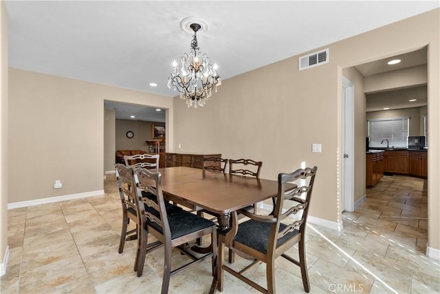 dining area with a notable chandelier and sink