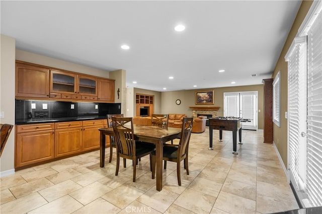 dining area with a stone fireplace