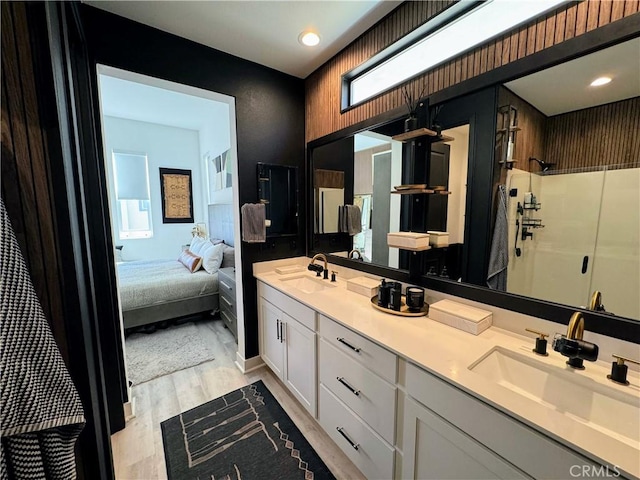 bathroom featuring vanity, hardwood / wood-style floors, and walk in shower