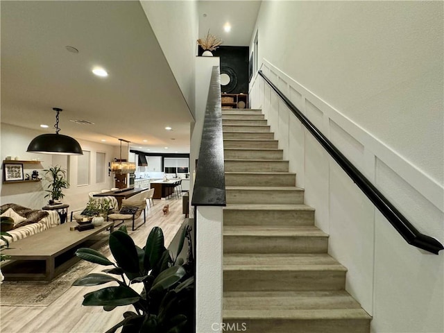 staircase with wood-type flooring