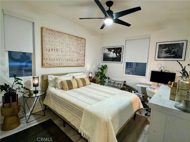 bedroom with ceiling fan and dark wood-type flooring