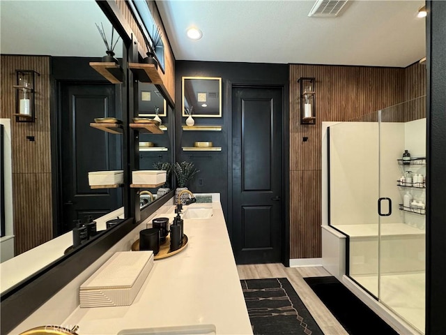 bathroom with vanity, wood-type flooring, and a shower with door