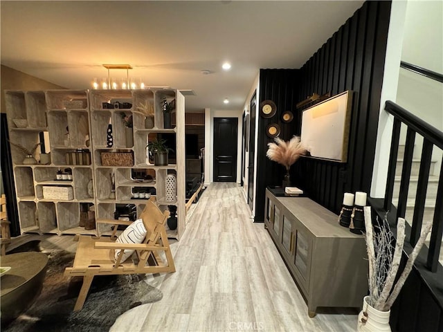 interior space featuring light hardwood / wood-style floors and a notable chandelier