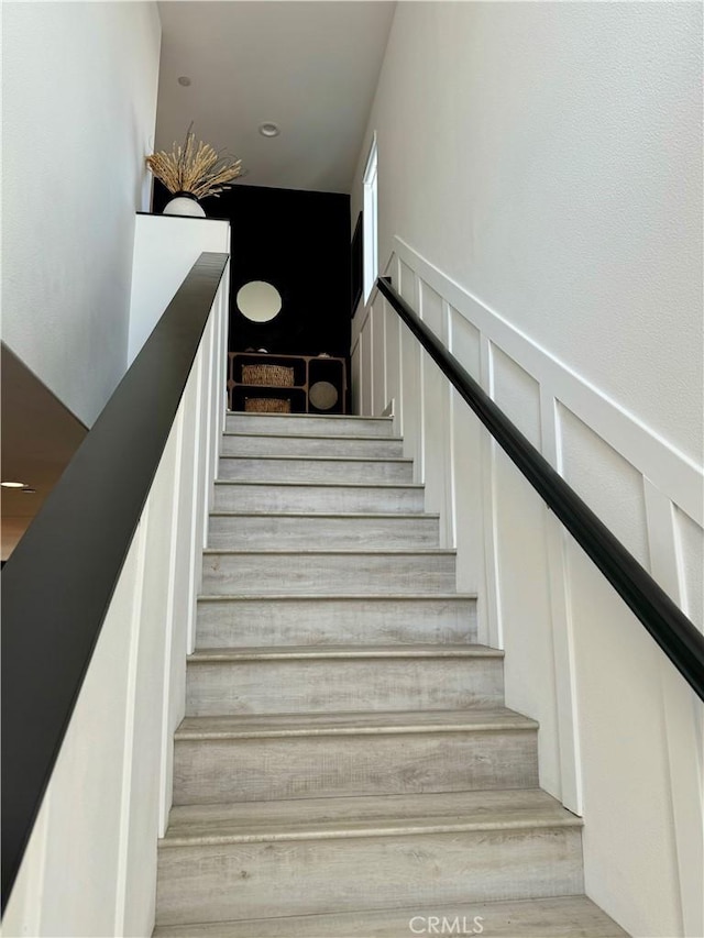 stairway featuring wood-type flooring