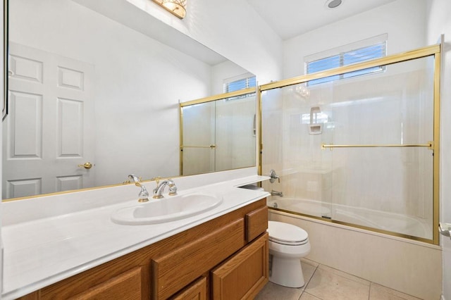 full bathroom with tile patterned floors, toilet, combined bath / shower with glass door, and vanity