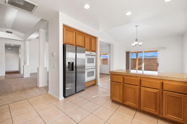 kitchen with white double oven, light colored carpet, an inviting chandelier, stainless steel fridge with ice dispenser, and lofted ceiling