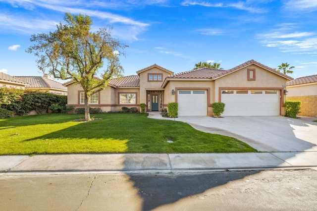 mediterranean / spanish home with a front yard and a garage