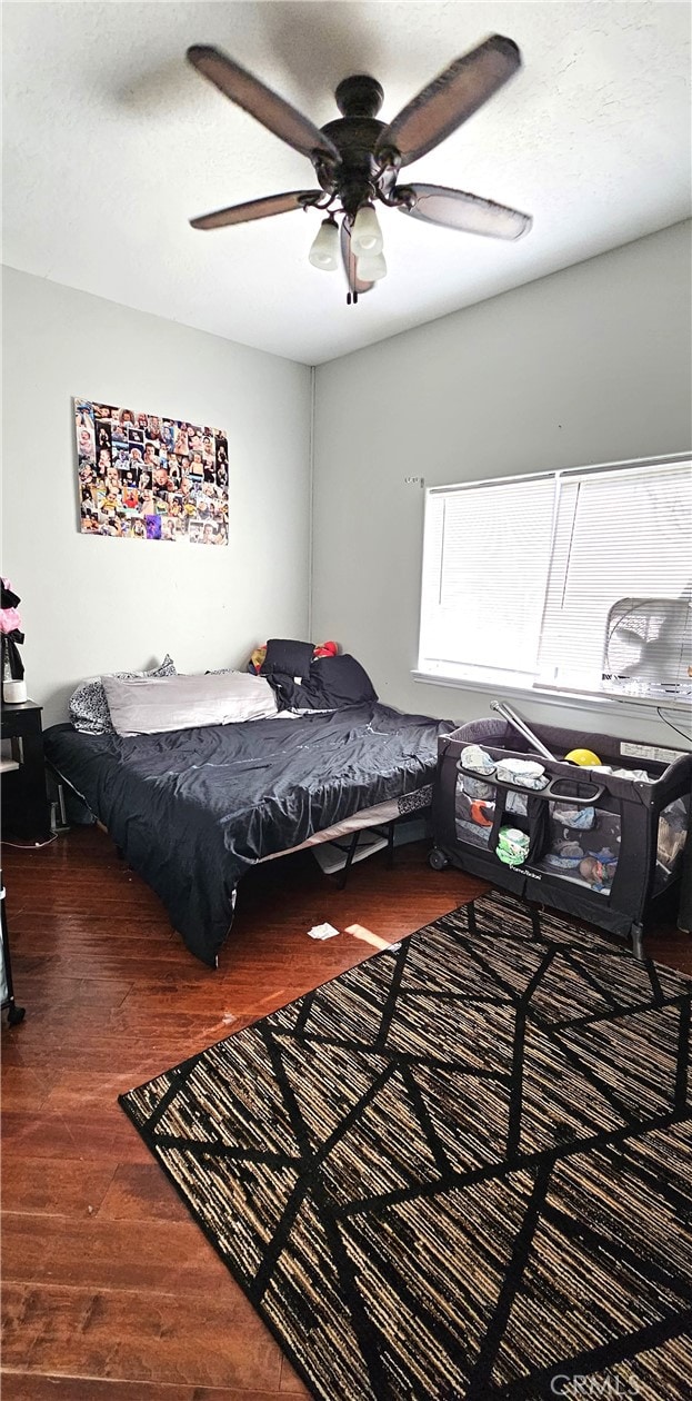 bedroom with ceiling fan and wood-type flooring