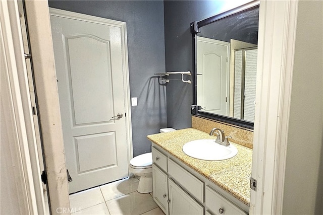 bathroom featuring tile patterned floors, vanity, and toilet