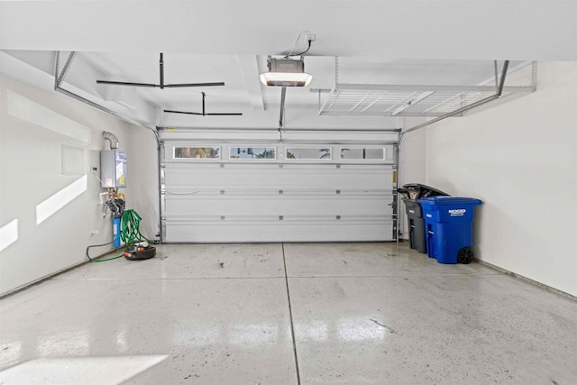 garage featuring a garage door opener and tankless water heater