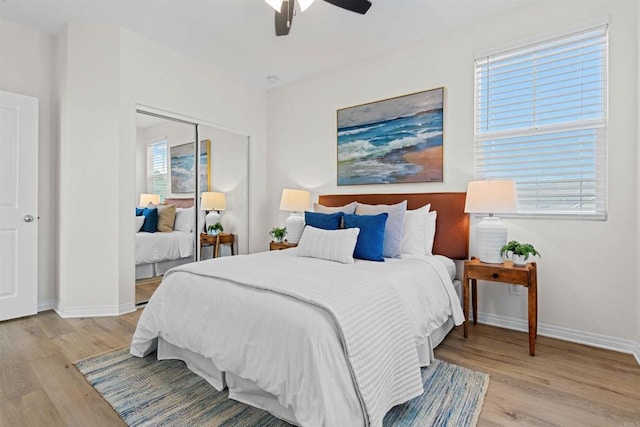 bedroom with a closet, ceiling fan, and light wood-type flooring