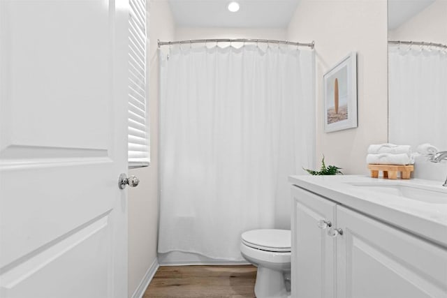 bathroom with vanity, hardwood / wood-style flooring, toilet, and a shower with shower curtain