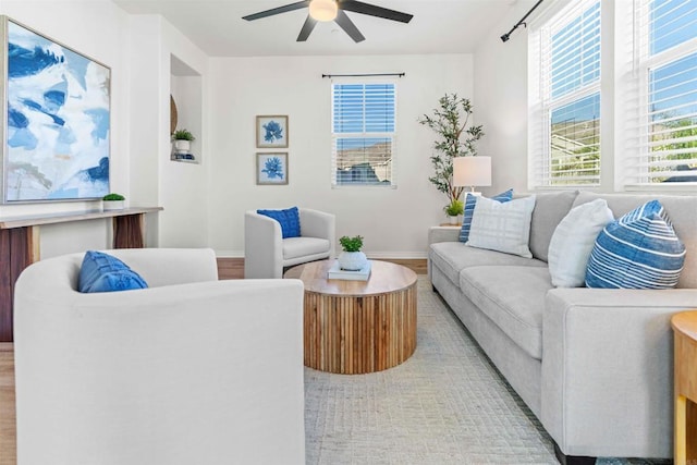 living room with light wood-type flooring and ceiling fan