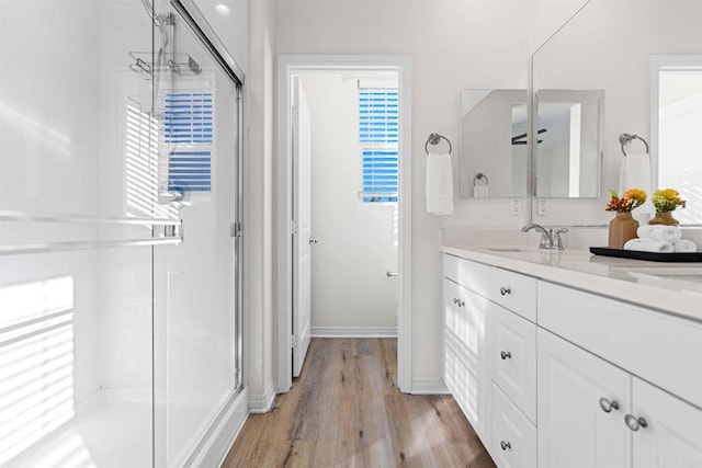 bathroom with vanity, wood-type flooring, and a shower with shower door