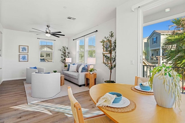 living room with hardwood / wood-style floors and ceiling fan