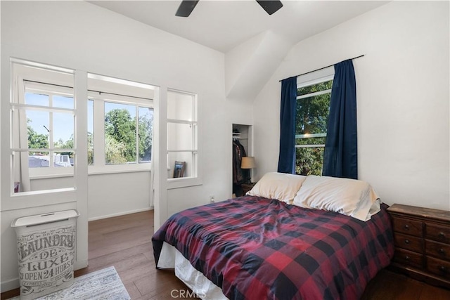 bedroom featuring multiple windows, ceiling fan, vaulted ceiling, and hardwood / wood-style flooring