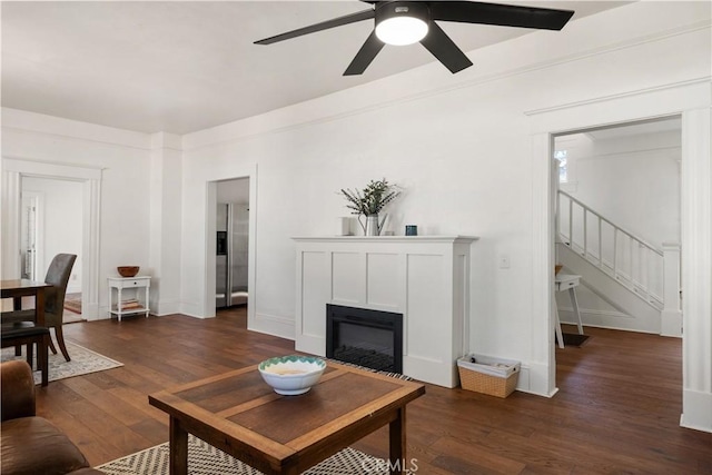 living room featuring dark hardwood / wood-style flooring and ceiling fan