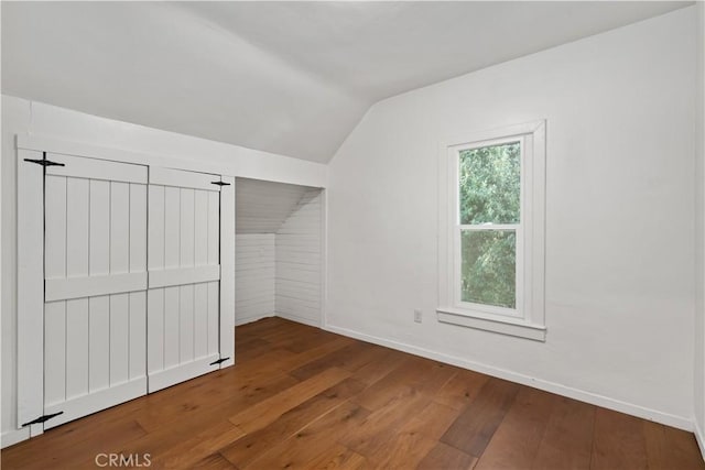 bonus room with hardwood / wood-style floors and lofted ceiling