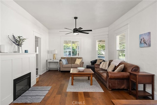 living room with ceiling fan and dark hardwood / wood-style floors