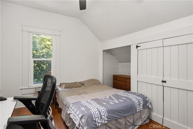 bedroom featuring hardwood / wood-style flooring, ceiling fan, and lofted ceiling