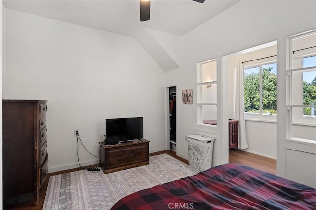 bedroom featuring ceiling fan, vaulted ceiling, and light wood-type flooring