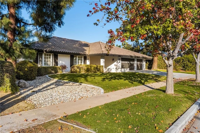 view of front of property featuring a garage and a front lawn