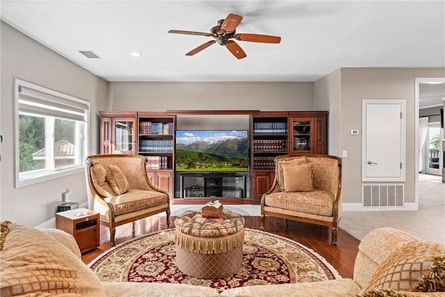 living room featuring hardwood / wood-style floors and ceiling fan