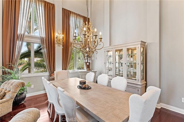 dining room featuring a chandelier and dark wood-type flooring