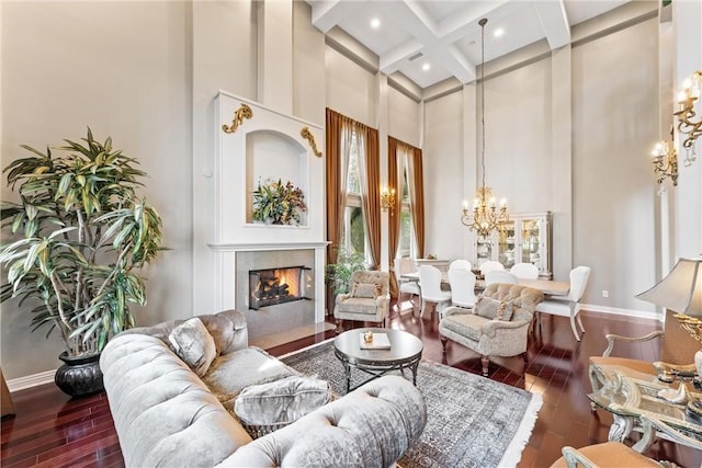 living area with a towering ceiling, coffered ceiling, a chandelier, beamed ceiling, and dark hardwood / wood-style floors