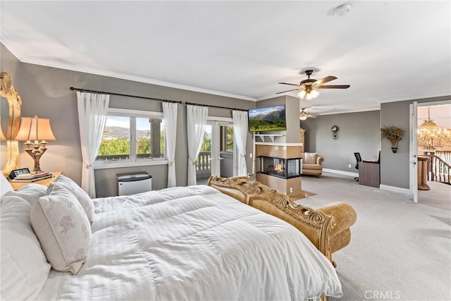 bedroom featuring a multi sided fireplace, ceiling fan, access to exterior, ornamental molding, and light colored carpet