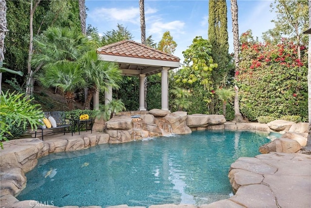 view of swimming pool with a gazebo and pool water feature