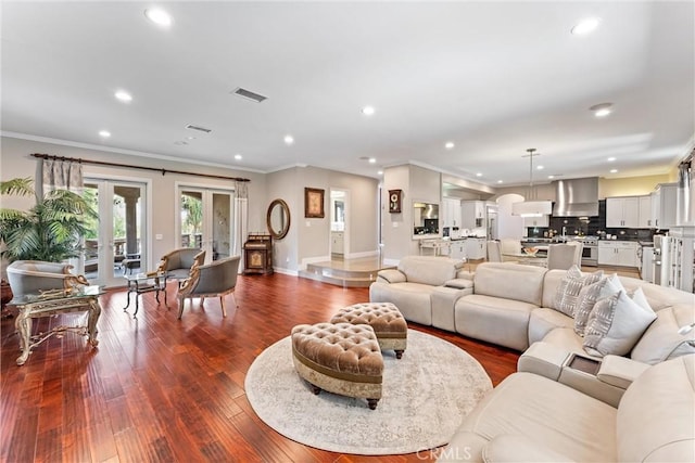 living room featuring ornamental molding, dark wood-type flooring, and french doors