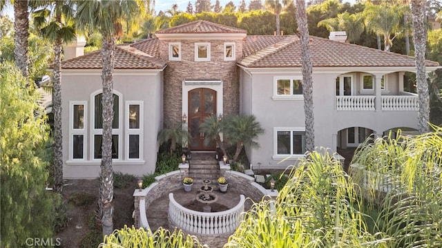 mediterranean / spanish home with a balcony