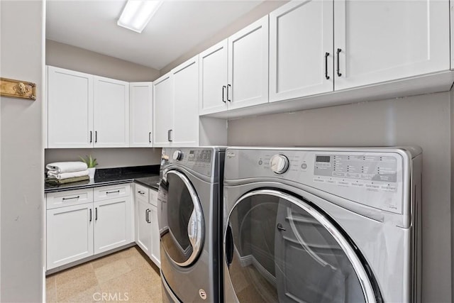 laundry room with cabinets and washing machine and dryer