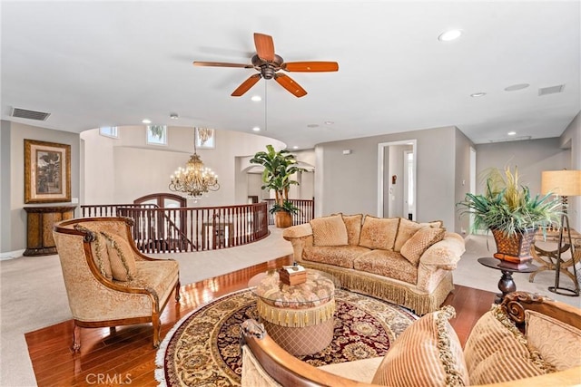 living room with carpet floors and ceiling fan with notable chandelier