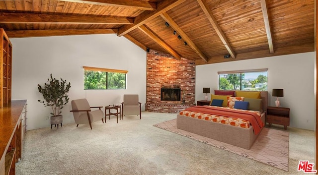 bedroom with wood ceiling, beamed ceiling, light colored carpet, and a brick fireplace