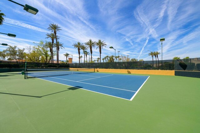 view of tennis court featuring basketball hoop