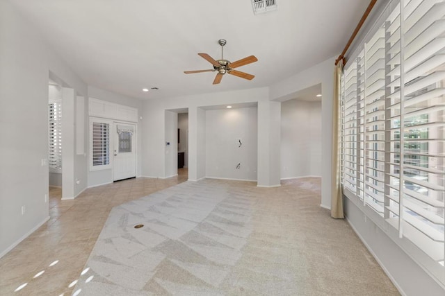 carpeted spare room featuring ceiling fan