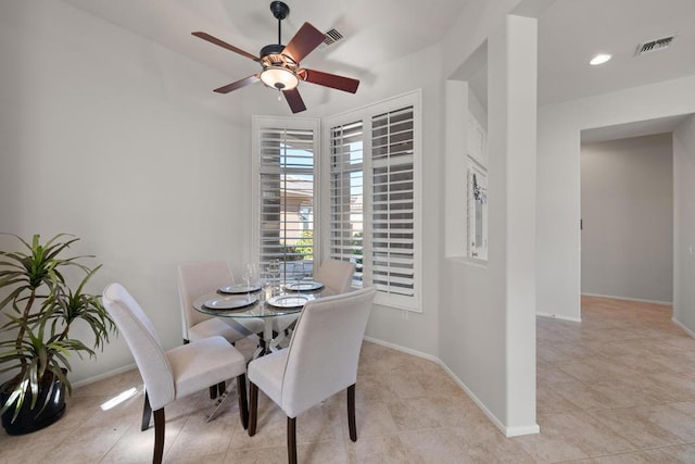 tiled dining space with ceiling fan