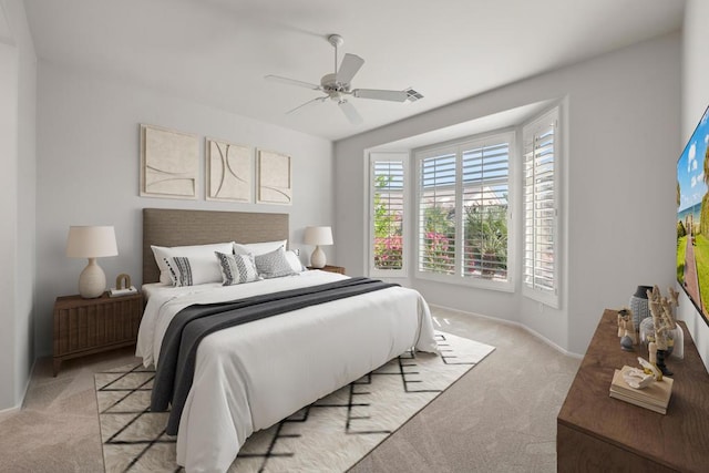 bedroom with light colored carpet and ceiling fan