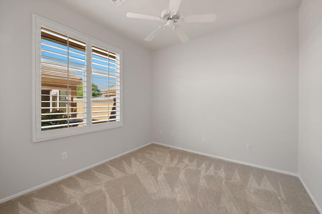 empty room featuring light colored carpet and ceiling fan