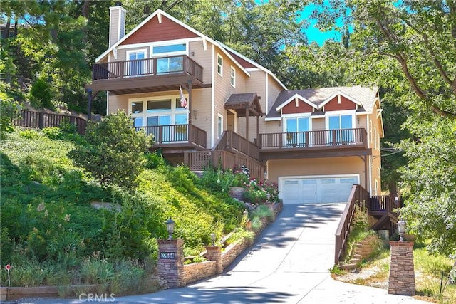 27554 N Bay Rd, Lake Arrowhead, CA 92352 - craftsman inspired home with a balcony, concrete driveway, a chimney, and a garage