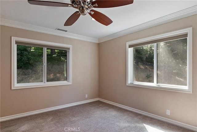 empty room featuring carpet floors, ceiling fan, and crown molding