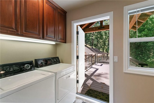 washroom with cabinets, washer and dryer, and light hardwood / wood-style floors