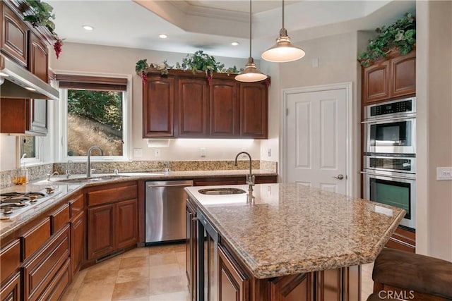27554 N Bay Rd, Lake Arrowhead, CA 92352 - kitchen featuring stainless steel appliances, light stone countertops, hanging light fixtures, a center island with sink, and ornamental molding